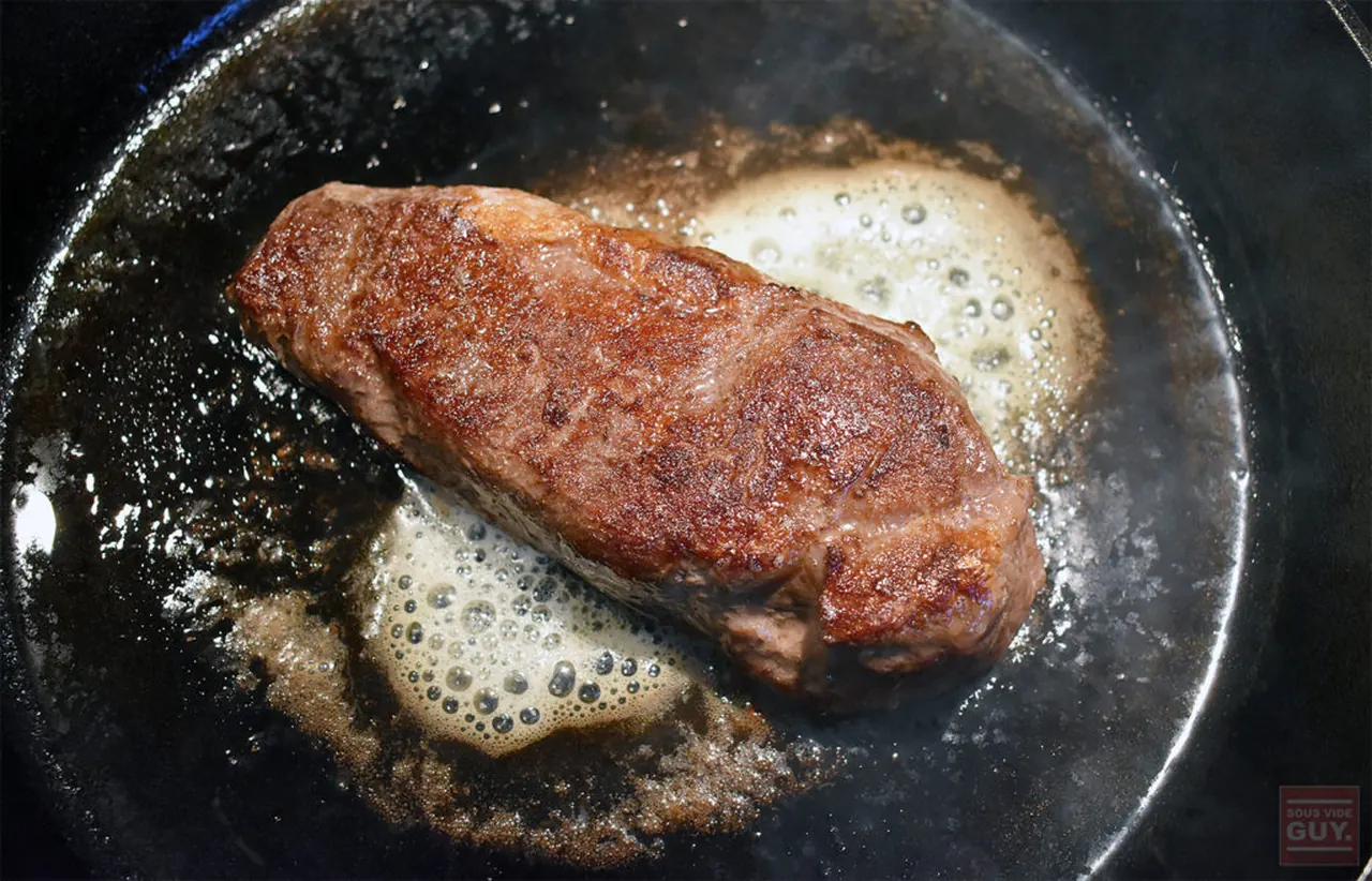 Steak searing in a cast iron pan
